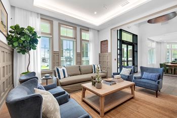 a living room with couches and chairs and a coffee table at The Enclave at Deer Moss Creek, Niceville, 32578